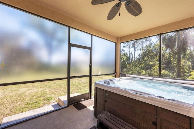 sunroom featuring ceiling fan, a wealth of natural light, and a hot tub