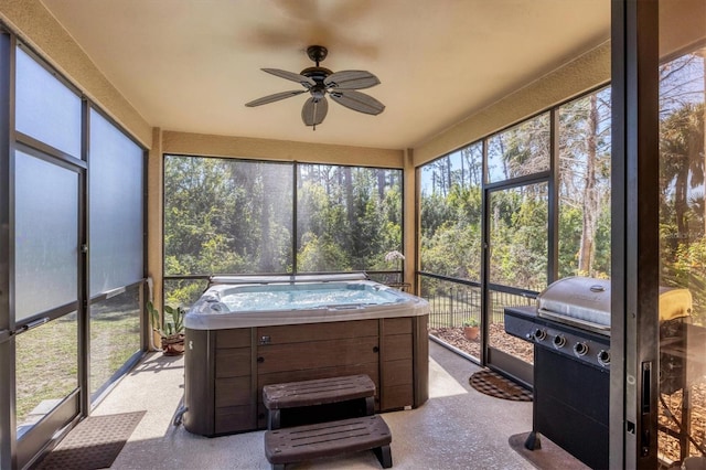 sunroom / solarium featuring ceiling fan and a hot tub