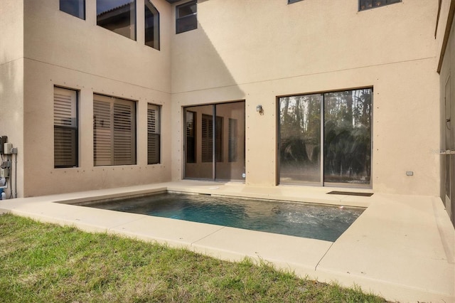 exterior space featuring a patio area, an outdoor pool, and stucco siding