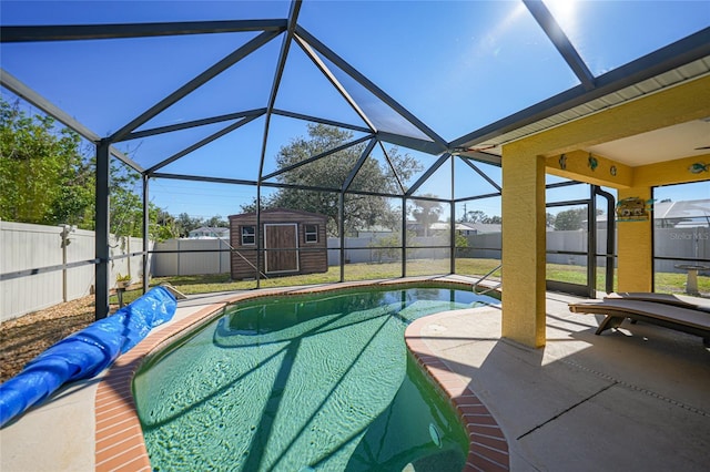 view of swimming pool featuring a storage shed, a patio, and glass enclosure