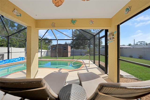 view of swimming pool with a lanai, a lawn, a patio, and a storage unit