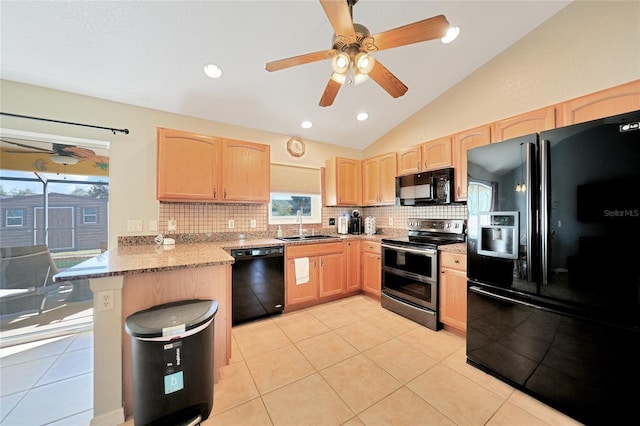 kitchen with sink, vaulted ceiling, light tile patterned floors, kitchen peninsula, and black appliances