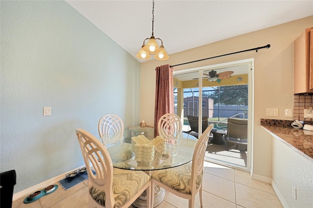 tiled dining space featuring vaulted ceiling and ceiling fan