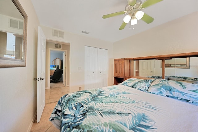 bedroom featuring light tile patterned flooring, ceiling fan, and a closet