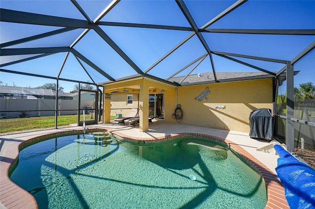 view of swimming pool featuring a lanai, grilling area, and a patio area