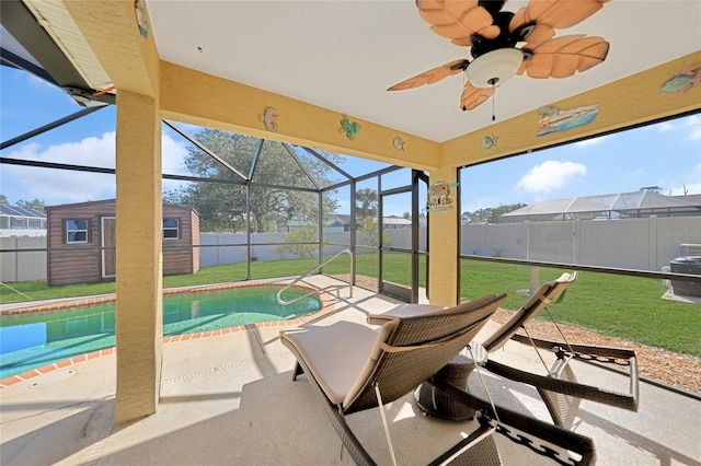 view of swimming pool with a storage shed, a patio area, and a lawn