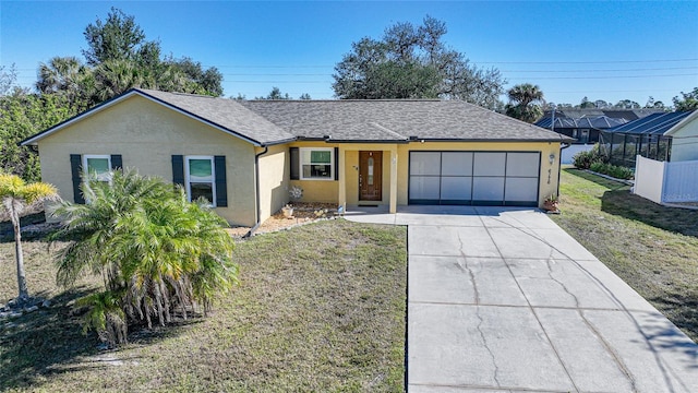 ranch-style house featuring a garage and a front yard