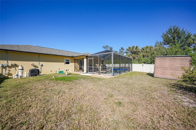 view of yard with a patio area and glass enclosure