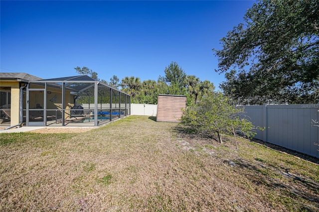 view of yard featuring a lanai, a fenced in pool, and a patio