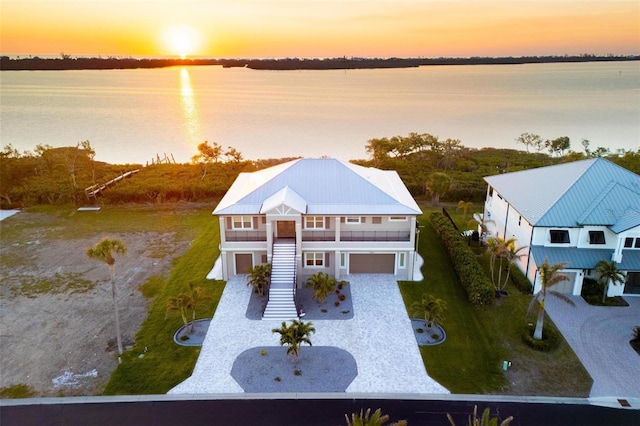 aerial view at dusk with a water view