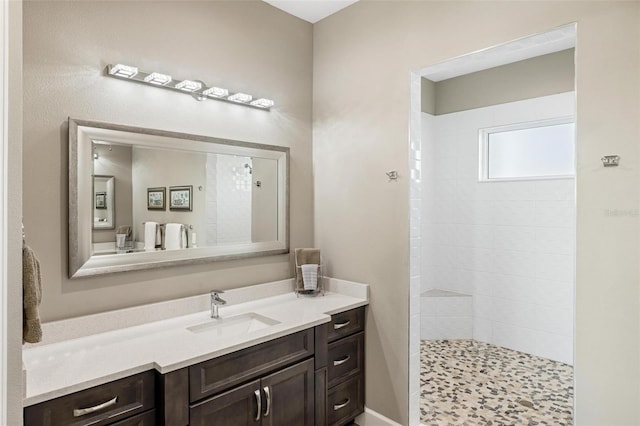 bathroom featuring vanity and a tile shower