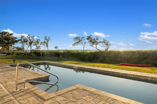 view of swimming pool with a water view