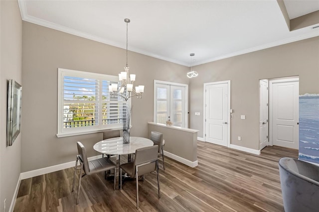 dining area featuring crown molding, a chandelier, and hardwood / wood-style floors