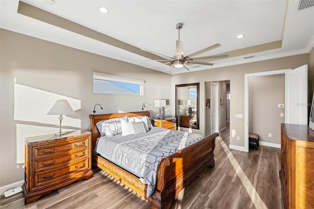 bedroom featuring crown molding, ceiling fan, a tray ceiling, and hardwood / wood-style floors