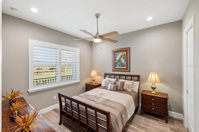 bedroom with ceiling fan and light hardwood / wood-style floors