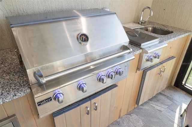 details featuring sink and light stone countertops