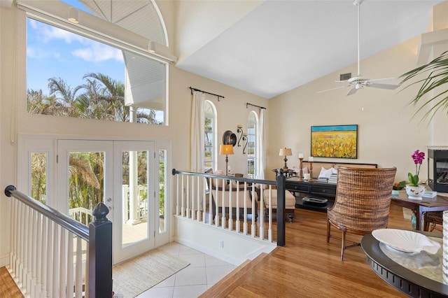 tiled entrance foyer featuring high vaulted ceiling, french doors, and ceiling fan