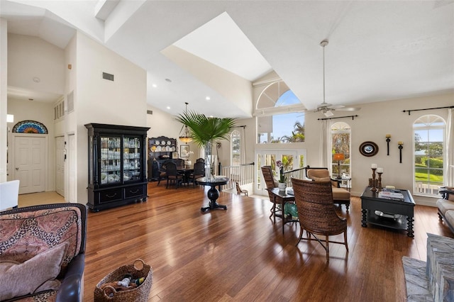 living room featuring hardwood / wood-style floors, high vaulted ceiling, and ceiling fan