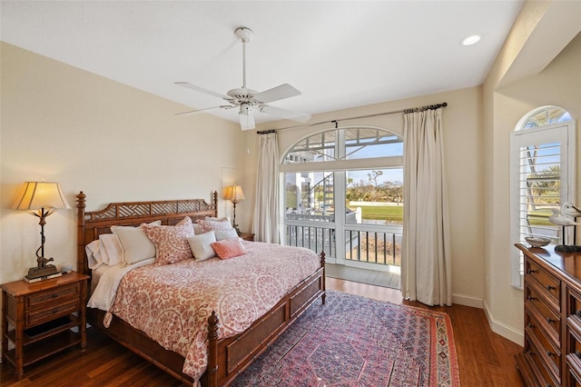 bedroom with dark wood-type flooring, ceiling fan, multiple windows, and access to outside