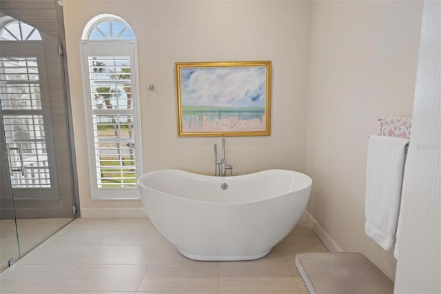 bathroom with tile patterned floors and separate shower and tub