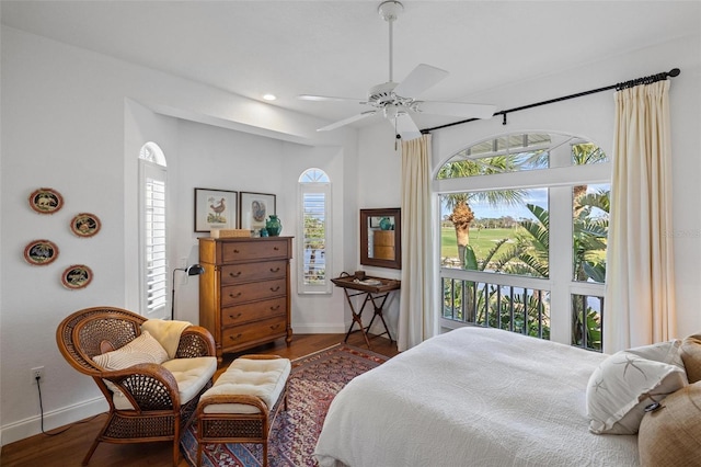 bedroom featuring multiple windows, dark wood-type flooring, and ceiling fan