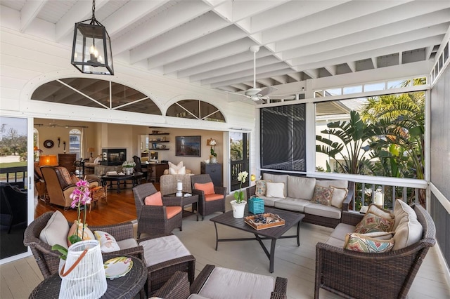 sunroom featuring beamed ceiling