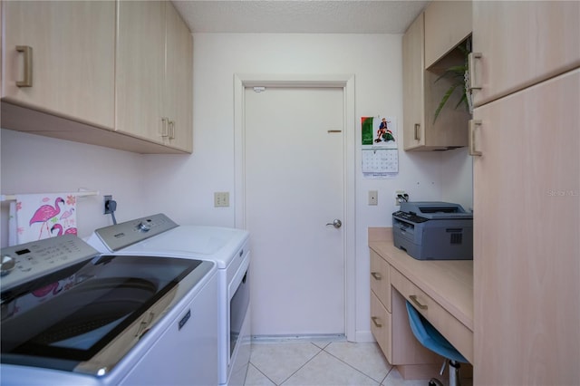 laundry area featuring cabinets, washing machine and dryer, light tile patterned flooring, and a textured ceiling