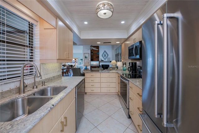 kitchen with light tile patterned flooring, appliances with stainless steel finishes, light brown cabinetry, and sink