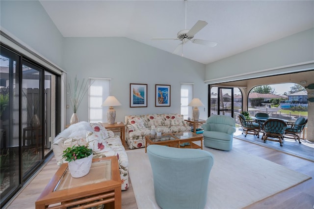 living room featuring lofted ceiling, light hardwood / wood-style flooring, and ceiling fan