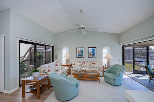 living room featuring lofted ceiling, wood-type flooring, and ceiling fan