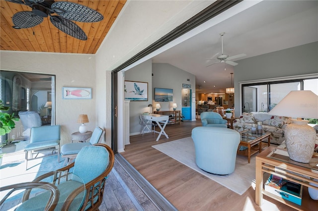 living room with hardwood / wood-style flooring, vaulted ceiling, wooden ceiling, and ceiling fan