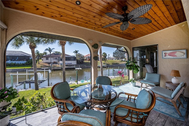 exterior space with vaulted ceiling, a water view, ceiling fan, and wood ceiling