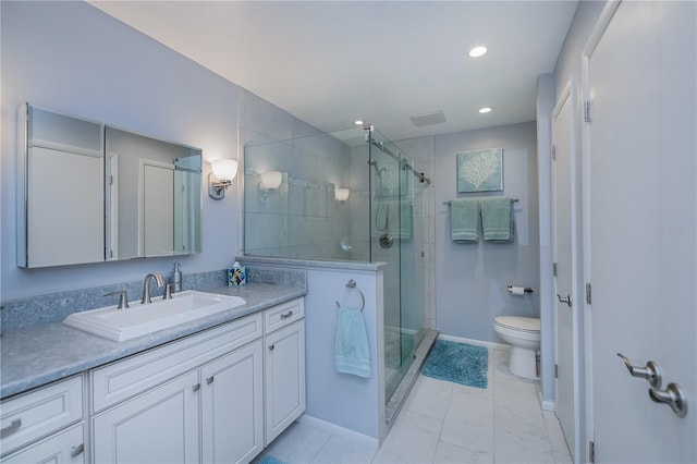 bathroom with vanity, toilet, and a shower with door