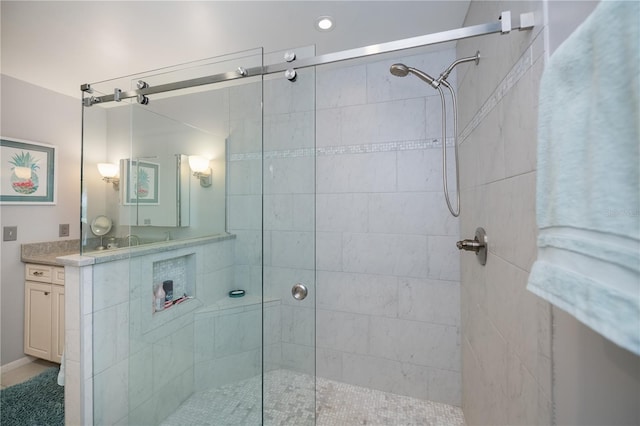 bathroom with vanity and a shower with door