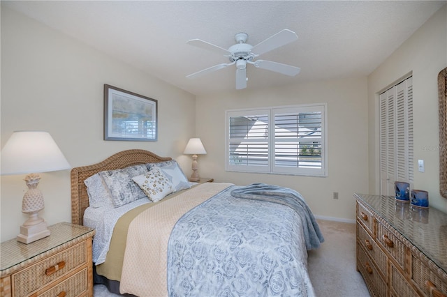 bedroom featuring light colored carpet and ceiling fan