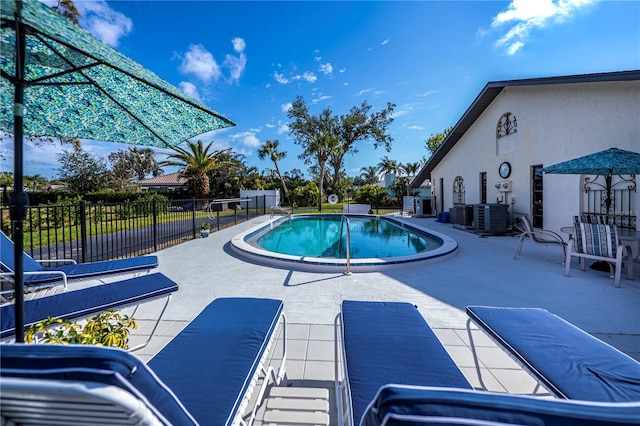 view of pool with central AC and a patio area