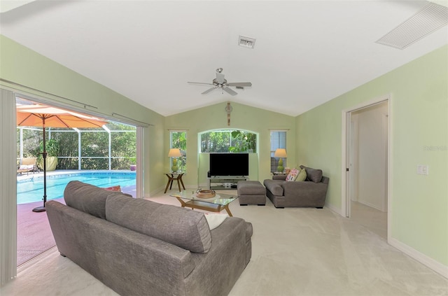 living room with lofted ceiling, light carpet, and ceiling fan