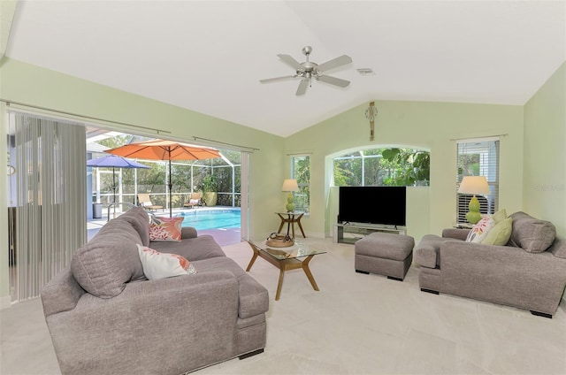 living room featuring vaulted ceiling, carpet, and ceiling fan