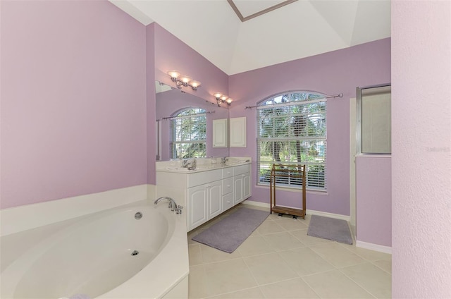 bathroom with vanity, a bath, tile patterned flooring, and a wealth of natural light