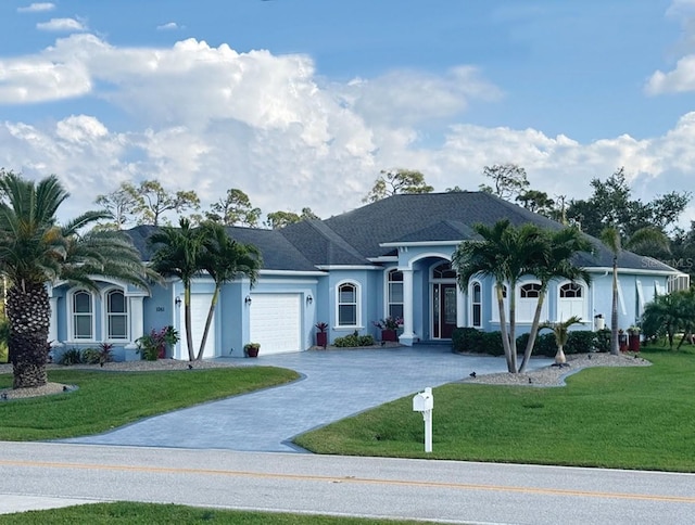 single story home featuring a garage and a front yard