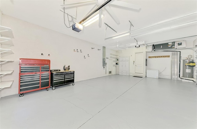 garage featuring a garage door opener, electric water heater, and a workshop area