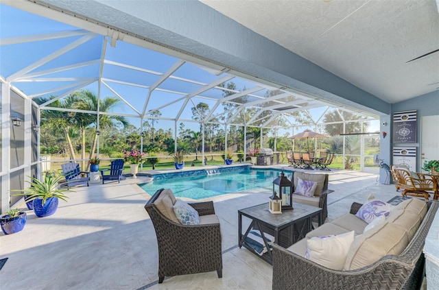 view of pool featuring a lanai, outdoor lounge area, and a patio