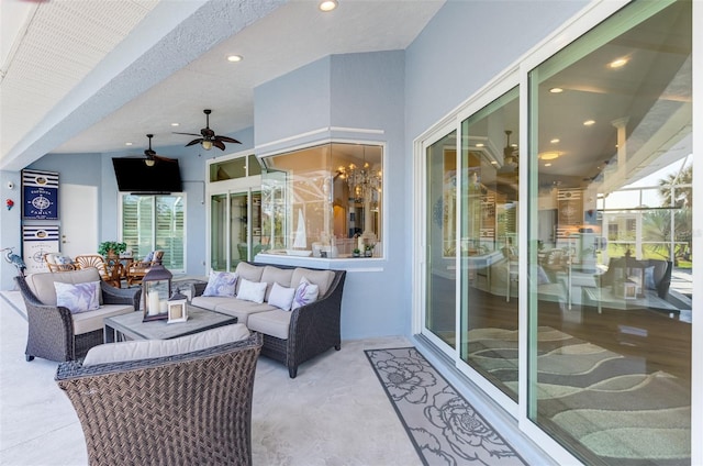 sunroom / solarium with ceiling fan with notable chandelier