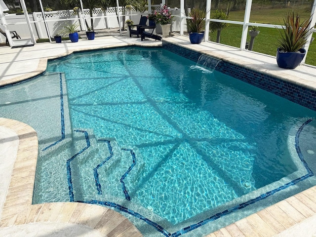 view of swimming pool featuring pool water feature, a patio, and glass enclosure