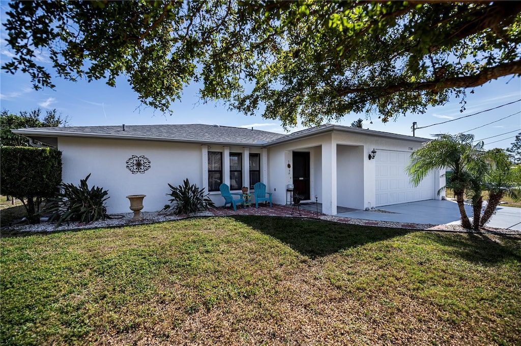 ranch-style home with a garage and a front yard