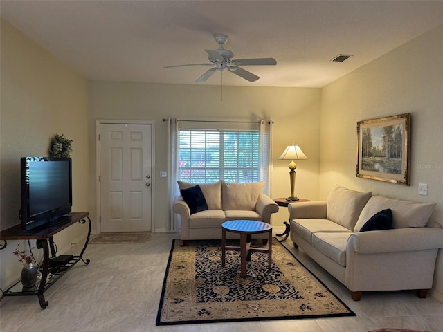 living room featuring light tile patterned floors and ceiling fan