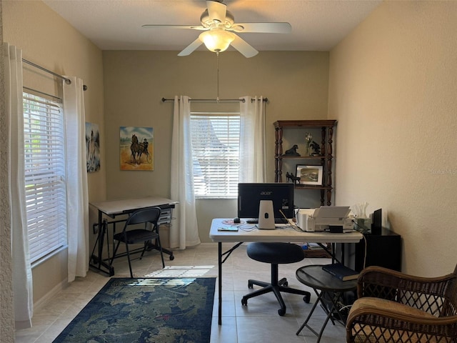 tiled home office featuring ceiling fan and a textured ceiling