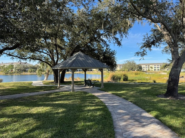 surrounding community featuring a gazebo, a water view, and a lawn