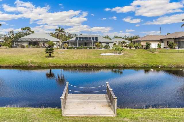 dock area with a water view and a yard