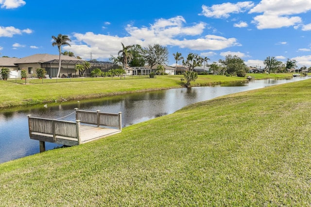 dock area with a water view and a lawn